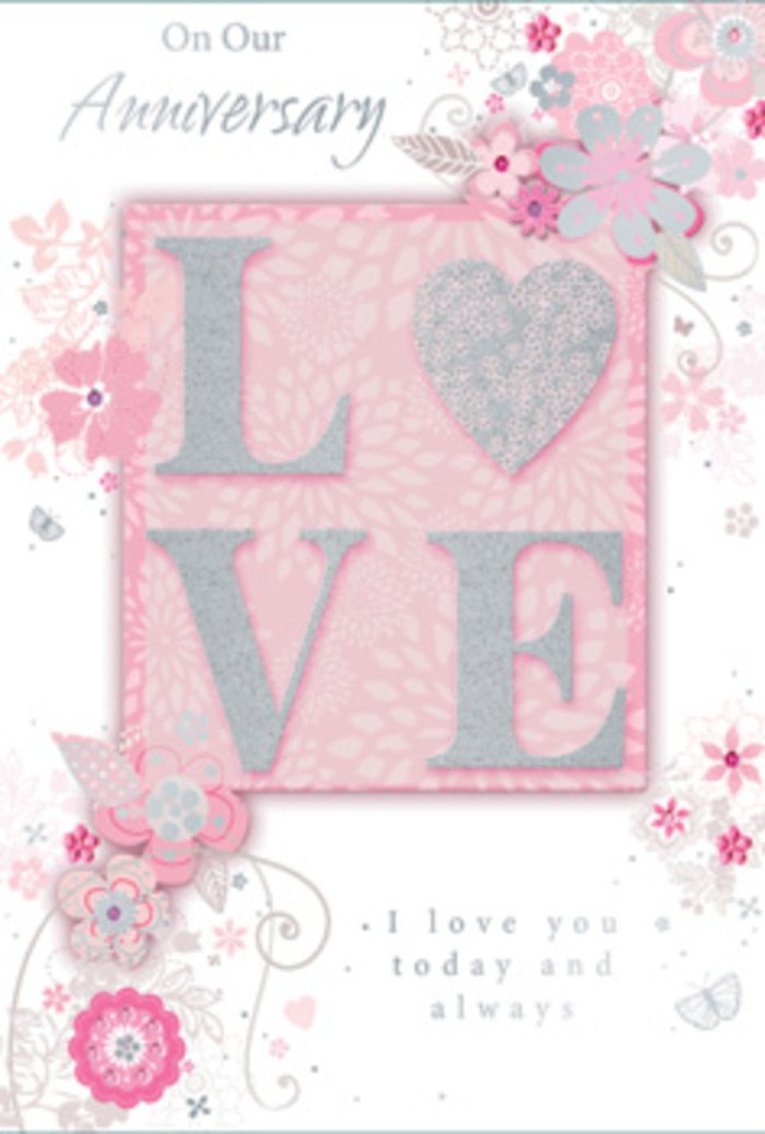 This image captures an anniversary card whose design echoes the softness and romance a florist might create for a couple in Old Oak Common marking years together. Across the centre of the card, the word LOVE stands out in prominent, raised letters, each stroke dusted with a fine layer of silver glitter that gives a gentle, tactile sparkle under the fingertips. The letters rest on a blush pink panel that subtly contrasts with the paler pink background behind it, creating a sense of depth like layers of petals in a fully open rose. Surrounding this central word, delicately illustrated flowers and looping vines cascade outward, their forms flowing and organic, reminiscent of stems and leaves gently curved by hand when arranging a bouquet. The blooms are drawn in a palette of soft pinks, mauves, and pearly whites, softened further by touches of grey and tiny silver accents, evoking the muted elegance of a spring garden at dusk. Fine lines and light shading give each flower dimension, as though they have been carefully sketched by someone accustomed to observing real blossoms, such as a local florist preparing arrangements for homes near Willesden Junction or along Old Oak Road. Tiny flourishes-petals, curls, and small, butterfly-like shapes-add quiet movement to the scene, suggesting the flutter of affection and shared memories. The card's message, written in a graceful script, speaks of enduring love and ongoing commitment, matching the calm, heartfelt atmosphere of the artwork. Together, the raised texture, soft colours, and intricate florals create a card that would feel perfectly at home beside fresh flowers delivered around Old Oak Common.